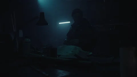 Bomb maker creating an explosive in the warehouse alone Video stock 256014842