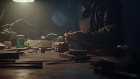 Bomb maker creating an explosive in the warehouse manually Stock Footage 256015810