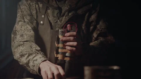 Bomb maker finishing an explosive device Stock-Footage 256011205