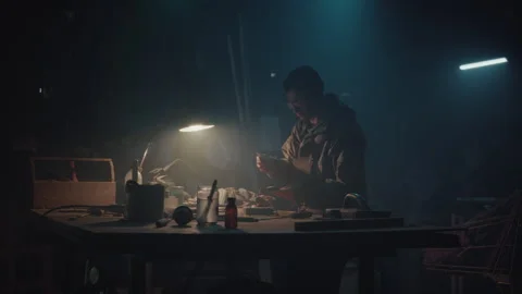 Bomb maker preparing the table and connecting the wires Stock Footage 256027467
