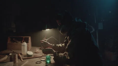 Bomb maker screwing something in the warehouse Stock-Footage 256000289