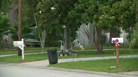 Bomb robot pick up suspicious package Stock Footage