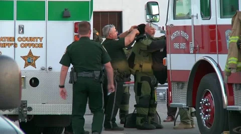 Bomb squad suiting up Stock Footage