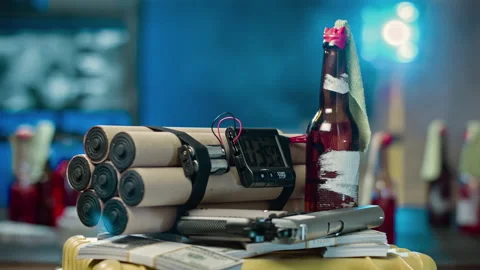 Bomb with a timer at close rotation. Near the money, gun and a molotov cocktail Stock Footage 100012114