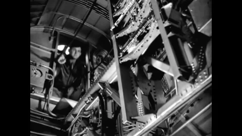 The bombardier of a B-17 is shown at work (with Jimmy Stewart narrating) in Stock Footage
