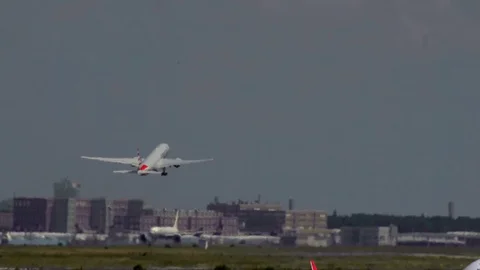 Bombardier on the background of an airplane taking off Stock Footage 102445790