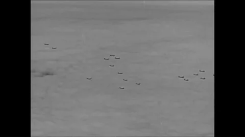 Bombers fly over Denmark encountering light enemy fire. Stock Footage 89629305