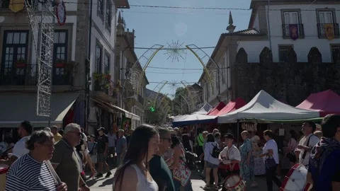 Bombo drummers march through the old town at Feiras Novas Ponte de Lima Stock Footage 346134315