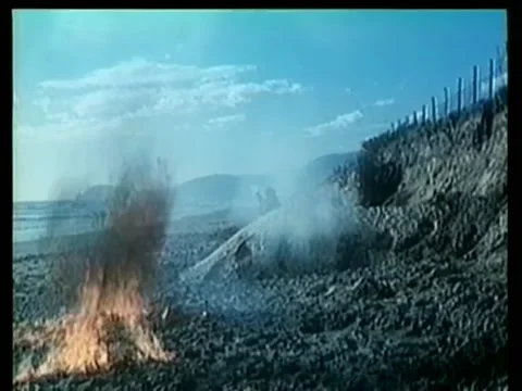 Bombs exploding on beach during gun battle 스톡 동영상 260247482