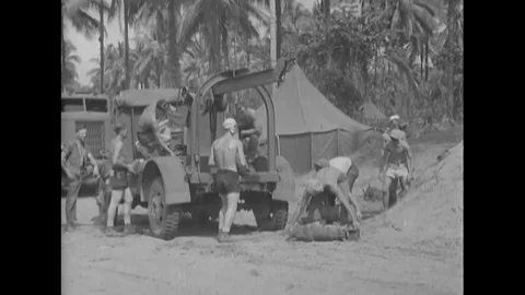 Bombs wrapped with shells are loaded onto a truck at Torokina Airfield on Stock Footage 101647734