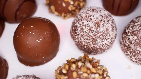 Bonbon chocolates closeup texture video on rolling rotating looping plate Stock Footage 104334592