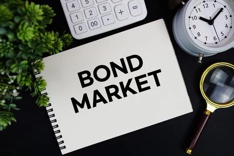 Bond Market text written on notepad with alarm clock, magnifying glass and .. Stock Photos