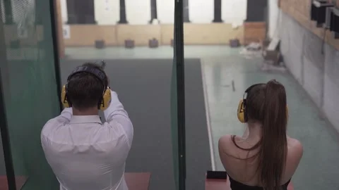 Bond Style Precision Elegantly Dressed Duo Shooting at the Range 4k slow motion Stock Footage 297082736