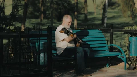 Bonding Time Senior Man and His Faithful Dachshund Companion in the Park Stock Footage 273968168