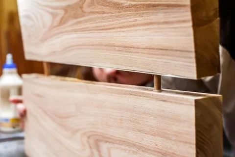 Bonding two planks in a carpentry workshop. Dowel and glue connection. Manufa Stock Photos