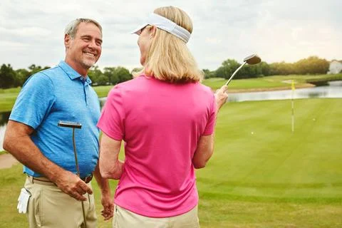 Bonding while out golfing. a mature couple out playing golf together. Fotos de archivo