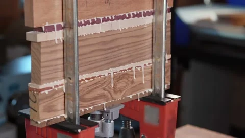 Bonding wood in the workshop. The use of glue for different types of wood Stock Footage 133251749