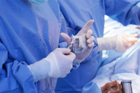 Bone cement application on knee implant during total knee arthroplasty Stock Photos