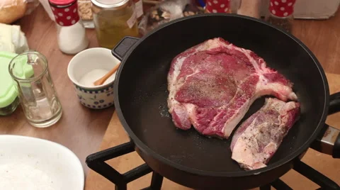 Bone steak roasting in non stick pan on hig heat Stock Footage 44610772