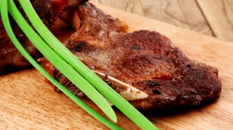 Boned roasted lamb ribs served with green chives Vídeos de archivo 27533545
