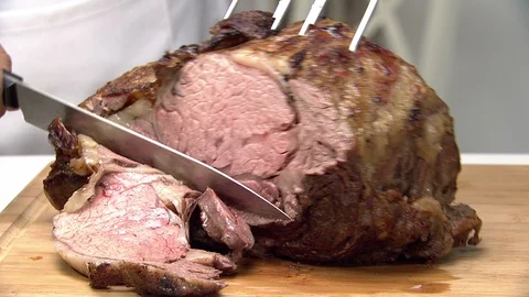 Boneless prime rib roast with quick camera push and large carving knife Stock Footage