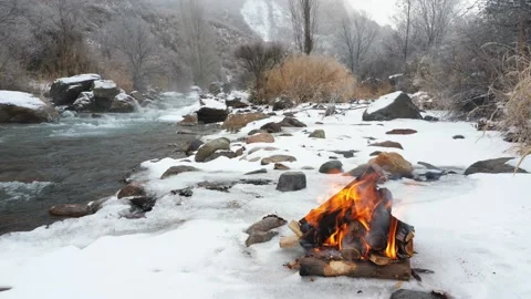 Bonfire on the bank of a winter river covered with fog. Stock Footage 144553763