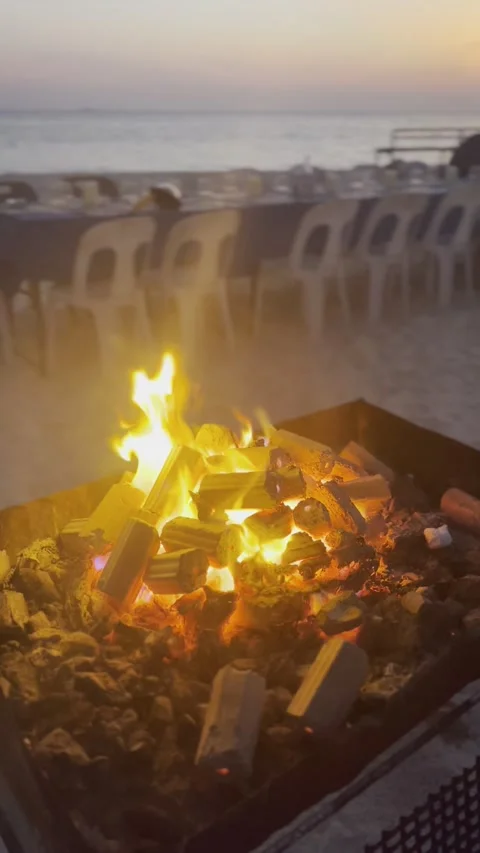 BONFIRE ON THE BEACH AT SUNSET Stock Footage 305277413