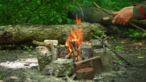 Bonfire is bred between two bricks. Mangal of bricks. Stock Footage 137192681