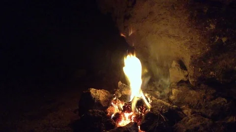 Bonfire burning in the dark cave 2 Stock Footage 73678895