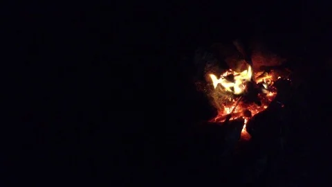 Bonfire burning in the dark cave .  View from the top Stock Footage 73678971
