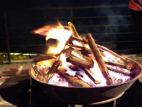 Bonfire Burning in Metal Fire Pit at Night at Mountain Camp Stock Photos