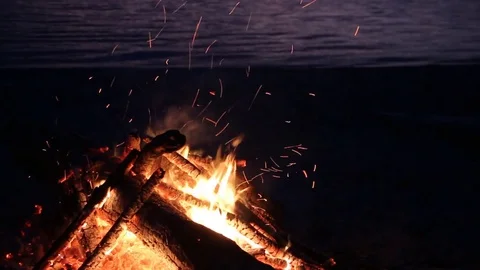 Bonfire burning on the river bank at night Stock Footage