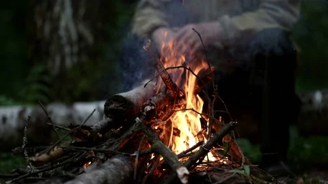A bonfire is burning. smoke rises. in the background, a person is seen out of Stock Footage 163665611