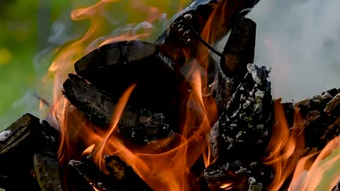 A bonfire burns. Close-up of flames. Summer evening. Slow motion. Close up of wo Stock Footage 274182786