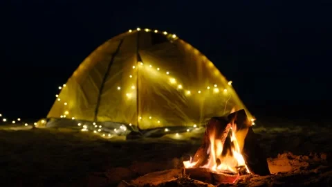 Bonfire Campfire at Camp Site on the background of camping tent and sea. Video stock 145574838