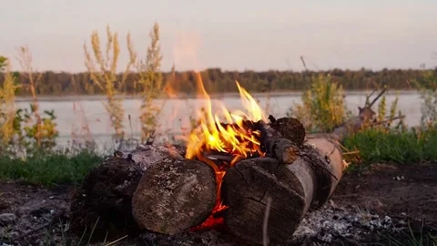 Bonfire close-up on the background of the river. The concept of hiking, outdoor Stock Footage 247501438