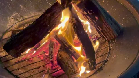A bonfire in a fire pit at night in a suburban backyard. Stock Footage 327630503