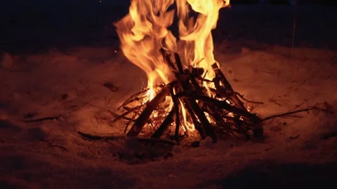Bonfire in the forest. Fire and bright flames illuminate the winter forest. Stock Footage 232650744
