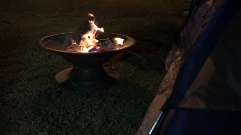 Bonfire infront of tent at night from back angle Stock Footage 54172144