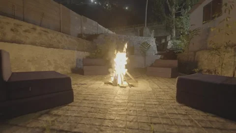 Bonfire at night with sofa seating Stock Footage 312446573