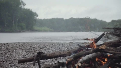 Bonfire o burns on the bank of a mountain river Stock Footage 120494053