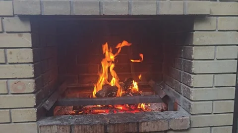 Bonfire with orange flame of burning firewood in the stove for cooking. Stock Footage 314939995
