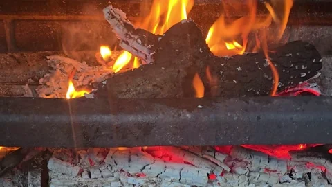 Bonfire with orange flame of burning firewood in the stove for cooking. Stock Footage 314940026