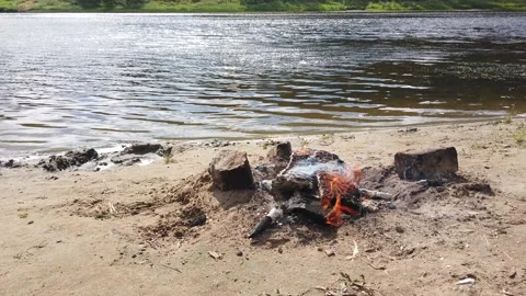 Bonfire by the river in summer Video stock 157046795