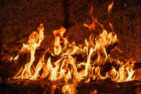 Bonfire by the rock. Stock Photos