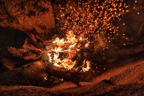 Bonfire by the rock. Stock Photos