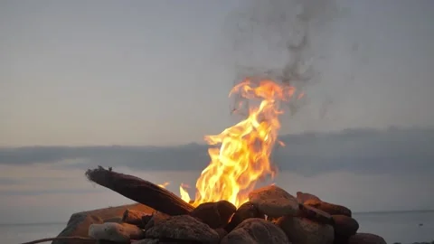 Bonfire On A Rocky Beach During Sunset Slow Motion 180FPS Stock Footage 169091529