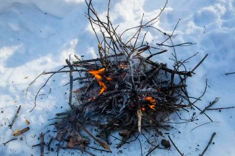 A bonfire on the snow in the winter. Stock Photos