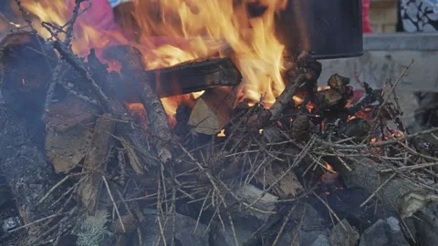 Bonfire with two cauldrons for cooking in the camp. Kindle Fire Video stock 169344100
