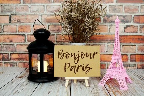 Bonjour Paris text message write on paper card with pink Eiffel tower souve.. Stock Photos